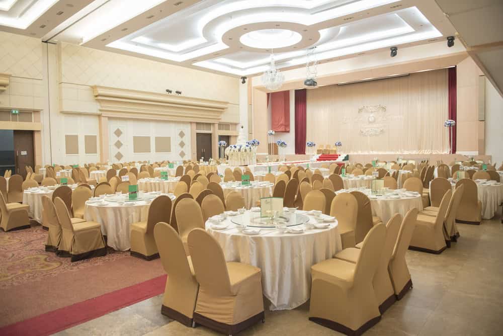 Banquet hall with tables and chairs set up for a wedding